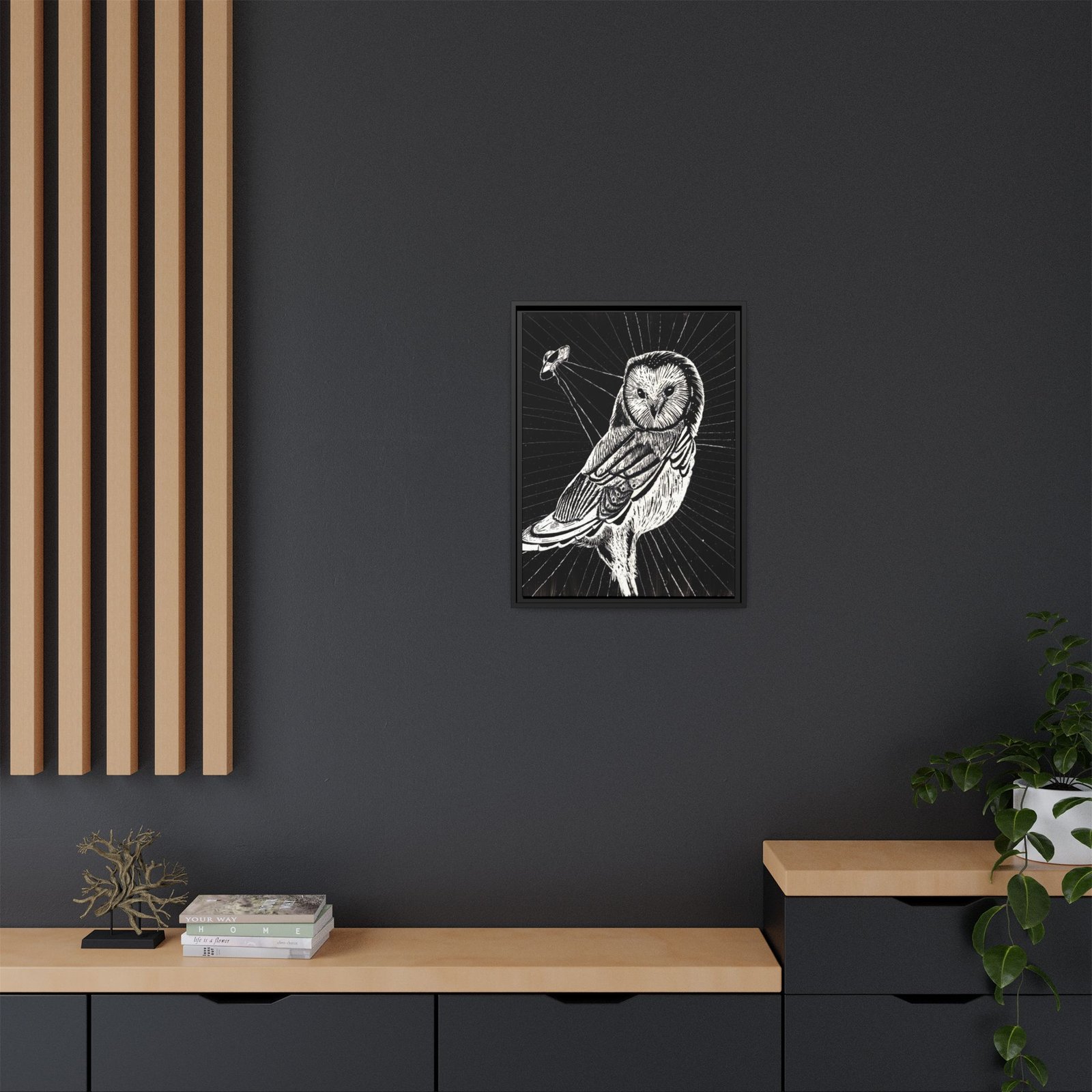 Framed monochrome UFO space owl canvas print with black frame hanging on wall