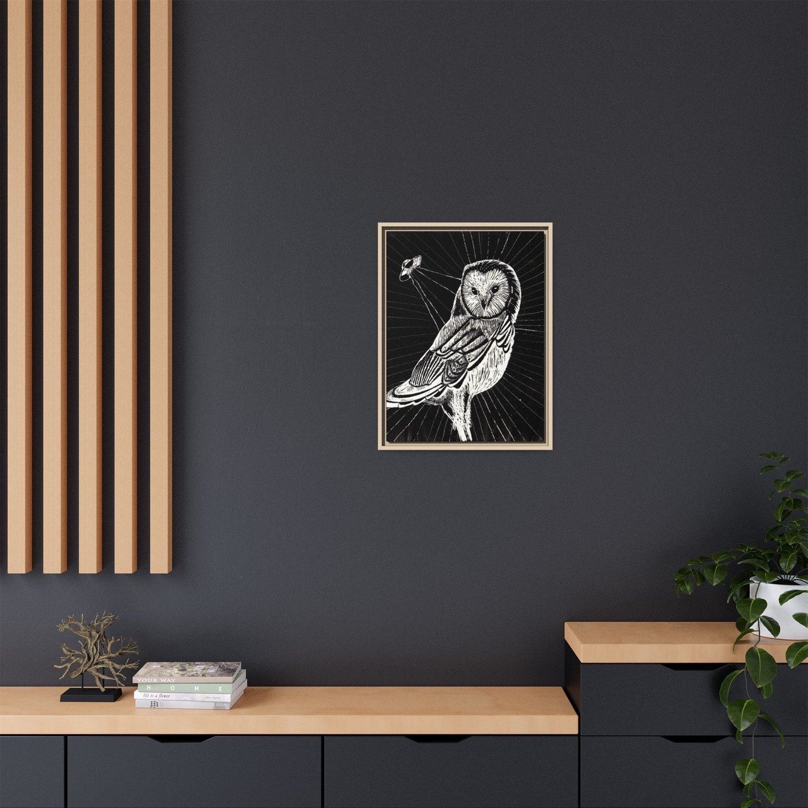 Framed monochrome UFO space owl canvas print with natural frame hanging on wall